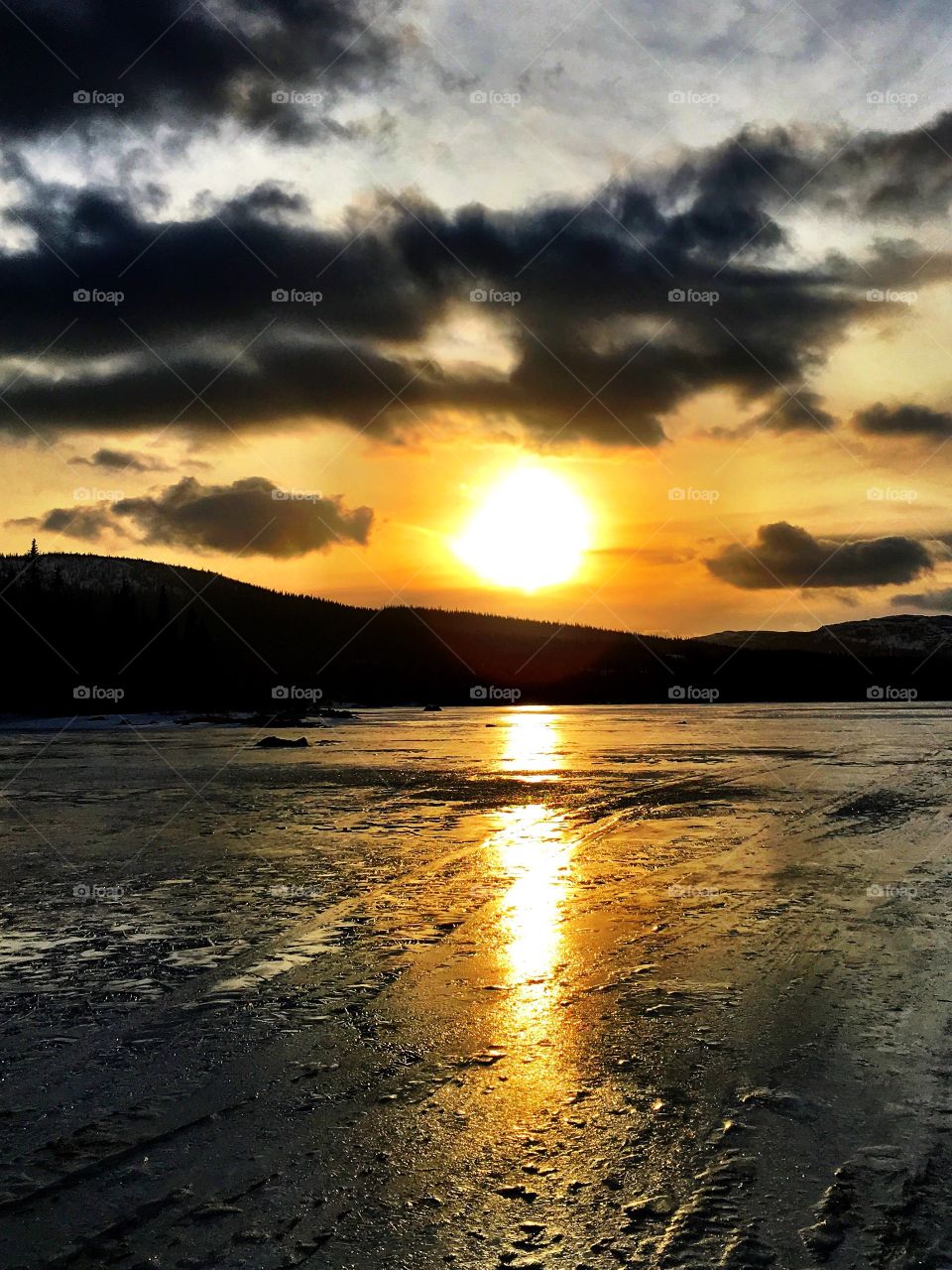 Sunset on icy lake 
