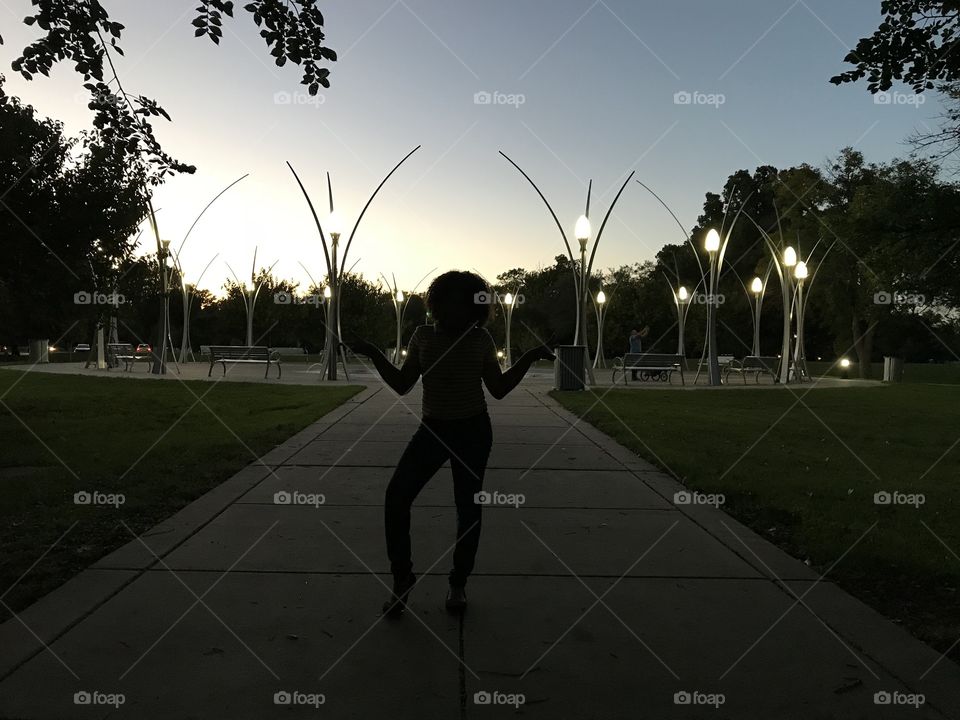 Girl Silhouette w Fountain and Lights background 