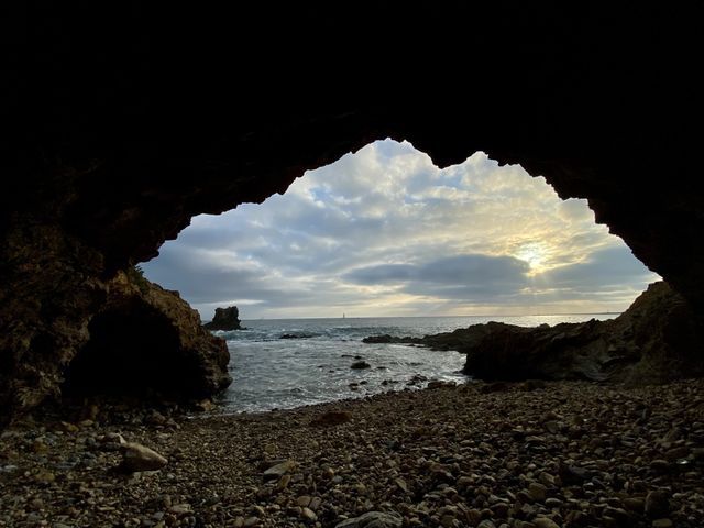 Sitting inside a cave watching the sunset on Cameo Shored Beach 
