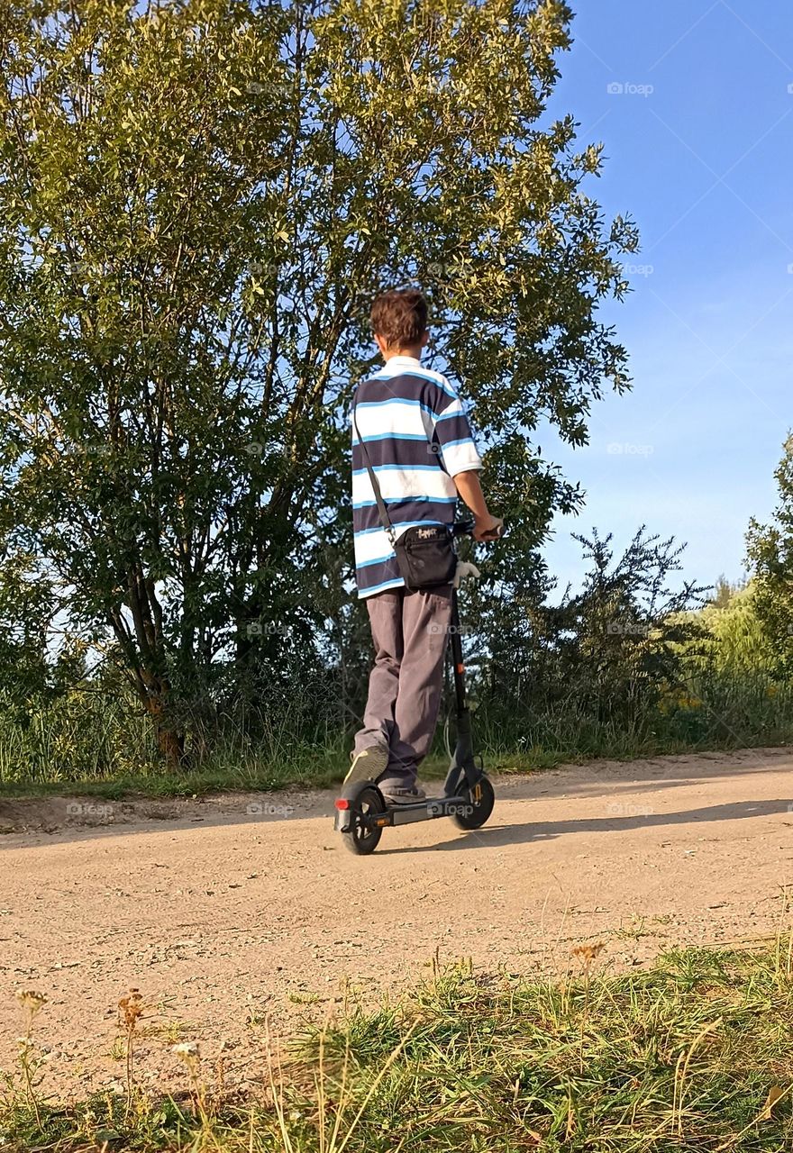 boy on a electric scooter, summer time