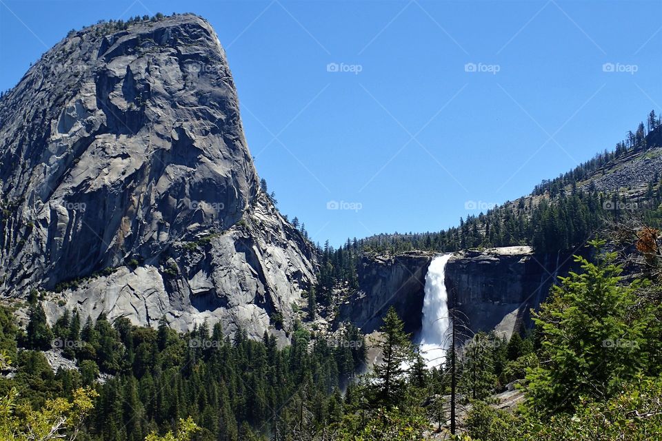 enjoying the view of a giant waterfall at Yosemite national park