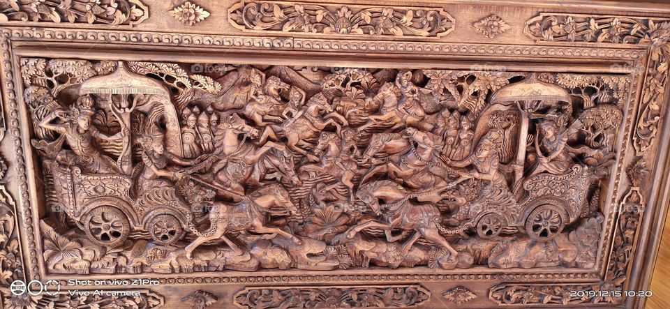 Indiana holy story Mahabharata carved on a wooden surface and it's so detailed and beautiful