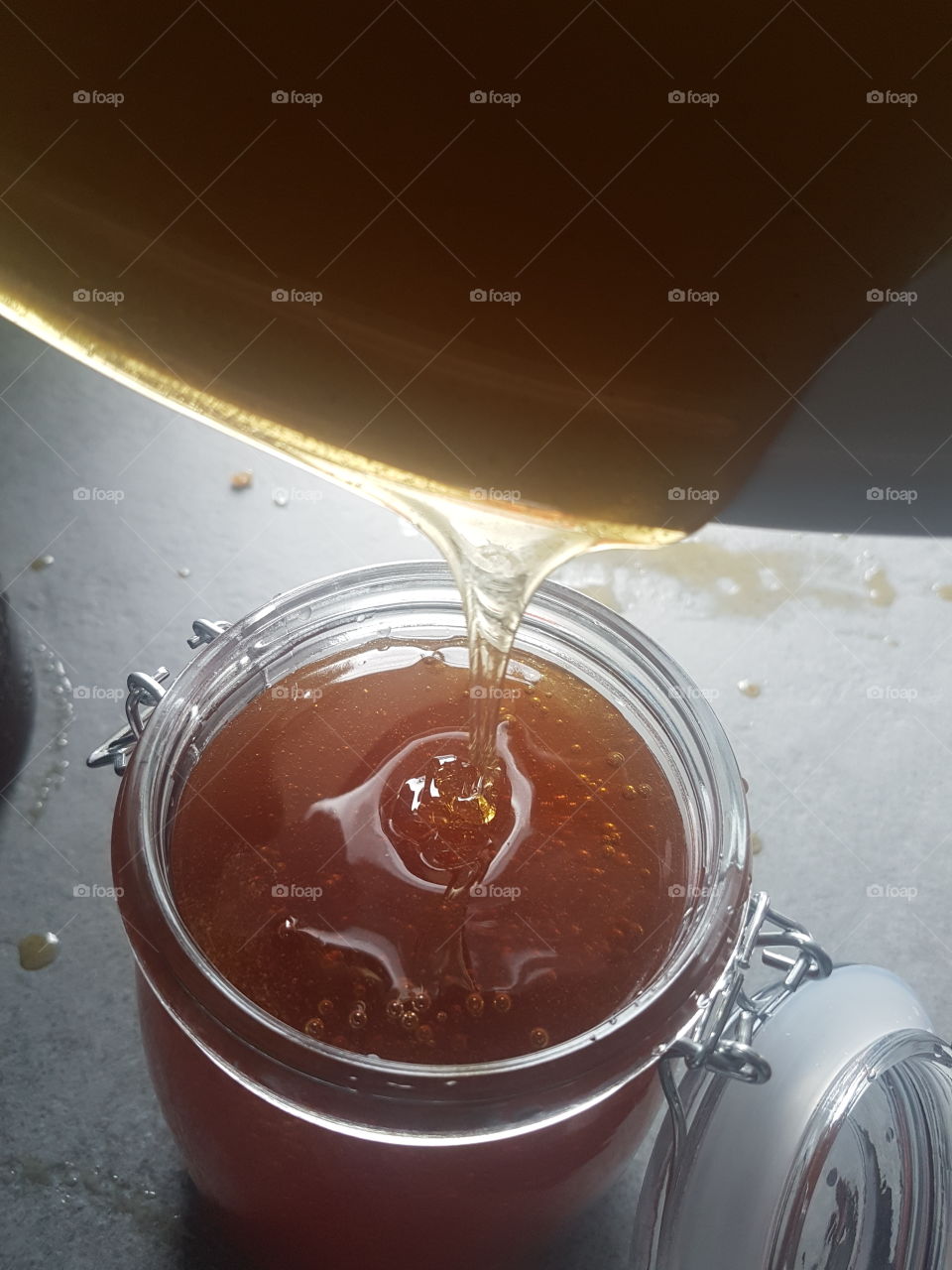 Pouring honey into jar