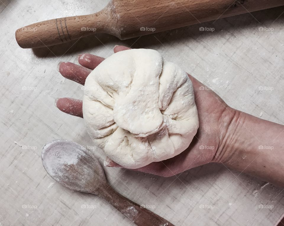 Woman hand holding dough