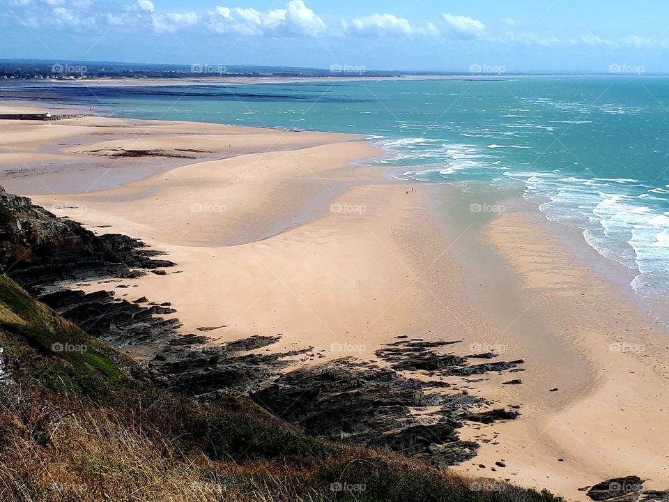view of the beach and the sea  from a cliff