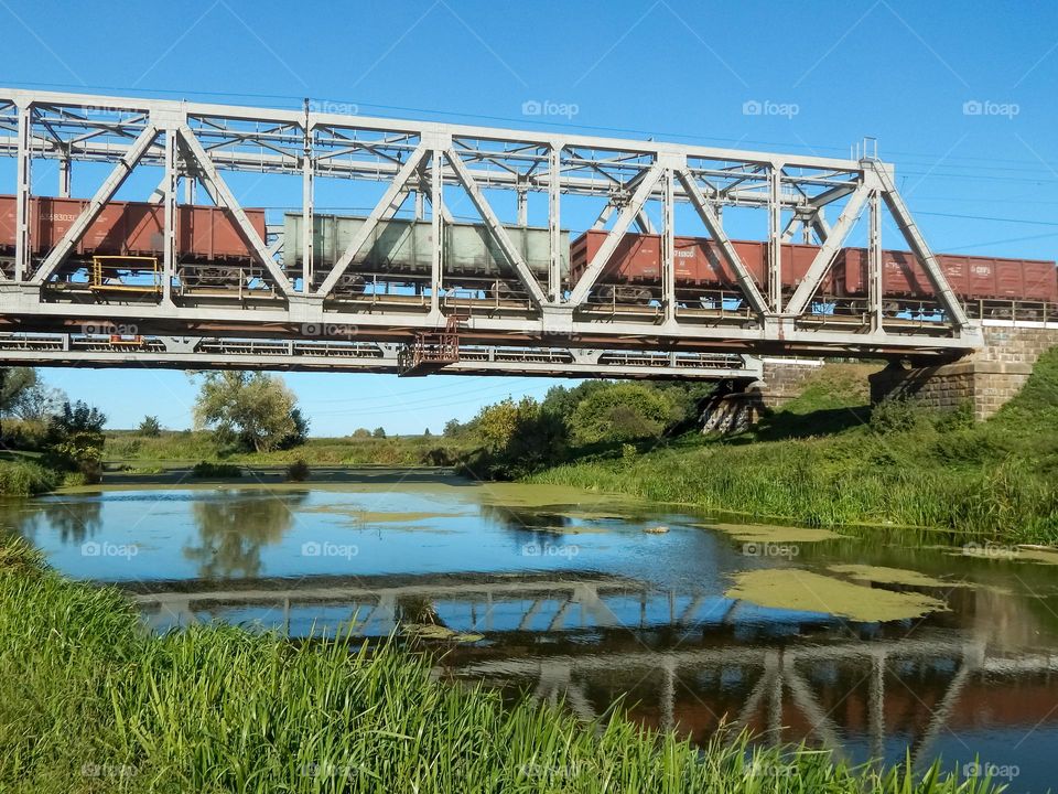 A train on a metal bridge, river, summer nature, Irpin, Ukraine
