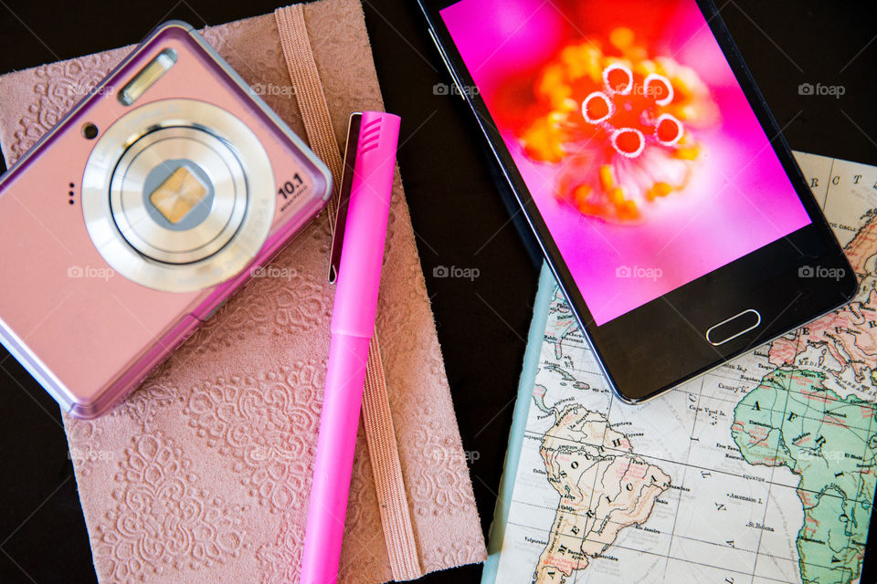 My daily routine, plan, write ideas, journal, take photos and enjoy life day by day! Image of pink notebook pen world map camera and smartphone with pink macro image of flower