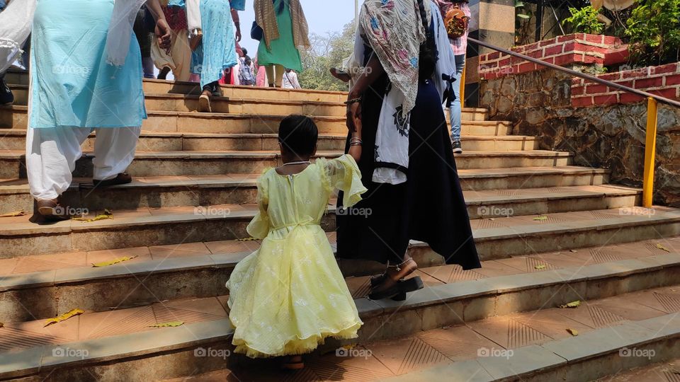 People climbing on the steps or roaming in the park