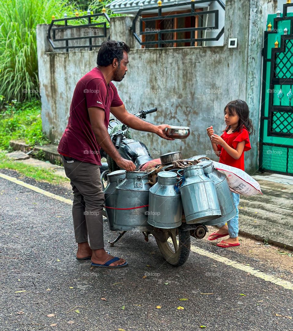 Milkman commuting on motorcycle 