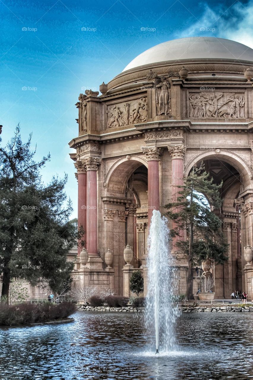 Vintage looking image of the landmark Palace of Fine Arts in San Francisco California with the fountain rising through the lagoon on a warm sunny afternoon