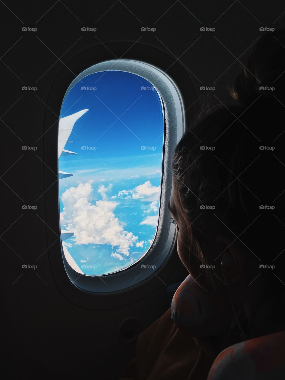 Girl looking out of airplane window