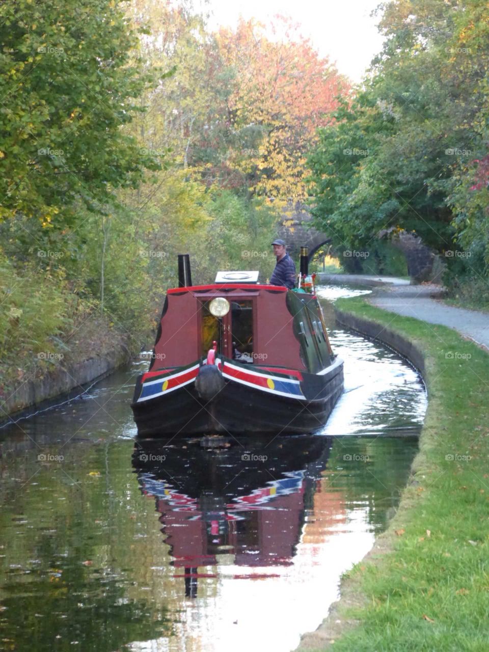 Reflection on river from canal boat