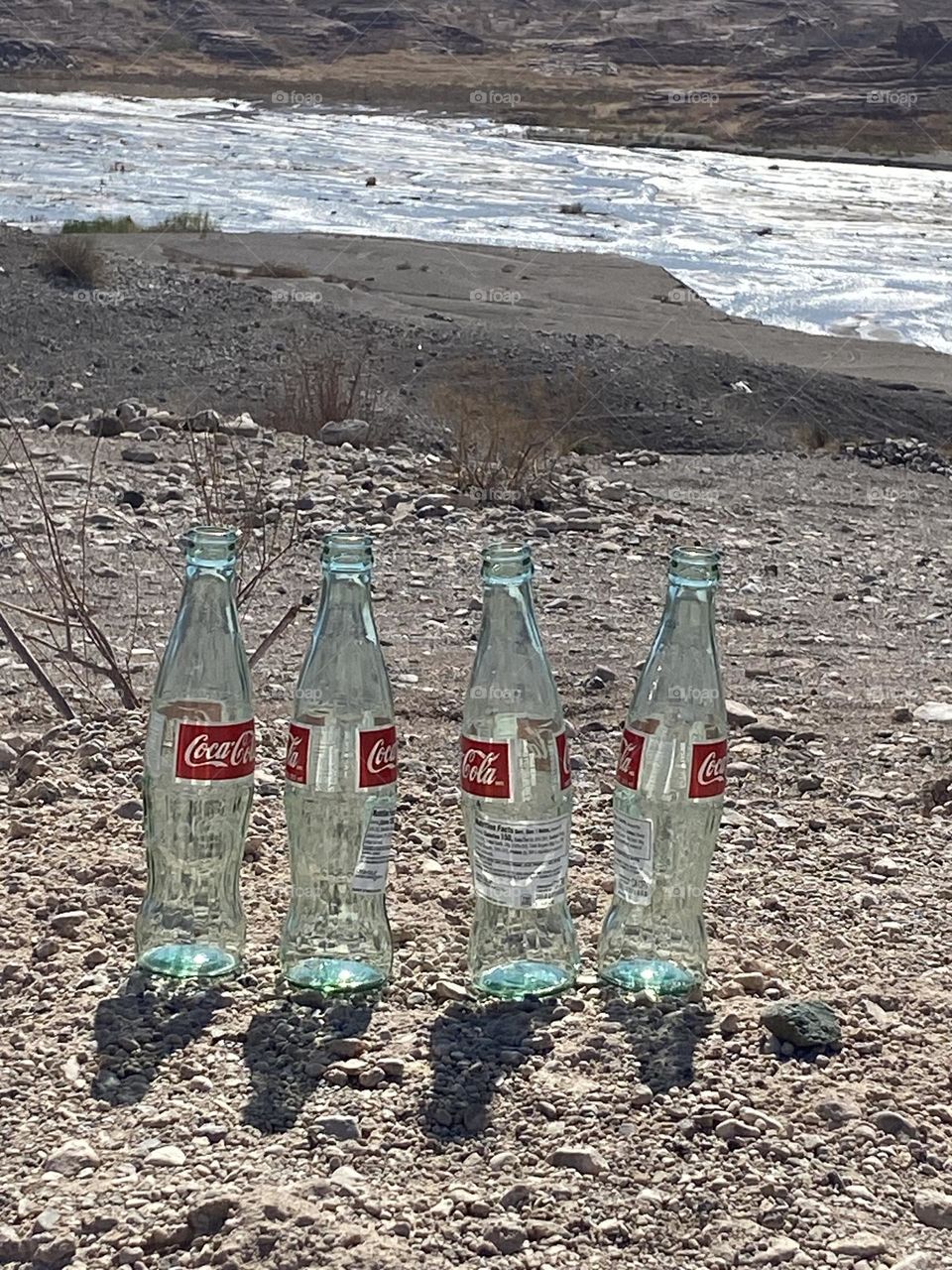 Coca Cola bottles with mountains