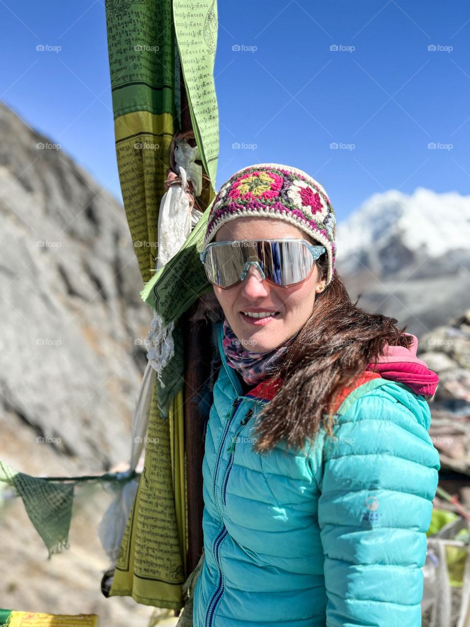 Woman on top of the mountain in the Himalayas, after hiking 3 hours for acclimatization.