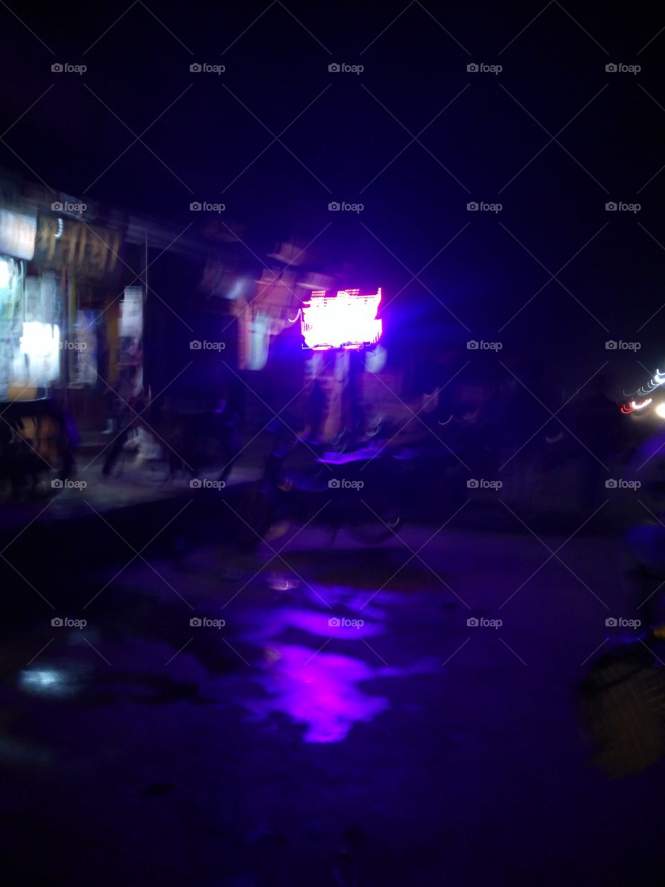 Illuminated light on street at night