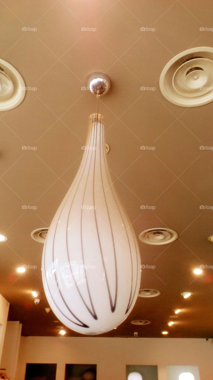 Long retro elegant lightbulb-shaped glass lamp indoors