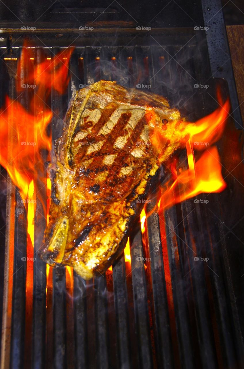Txogitxu Steak on a grill with flames