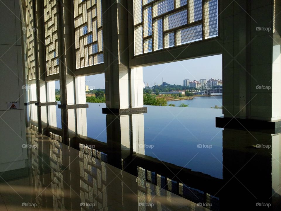 reflection. the wall's image is reflected on the water and tiled floor