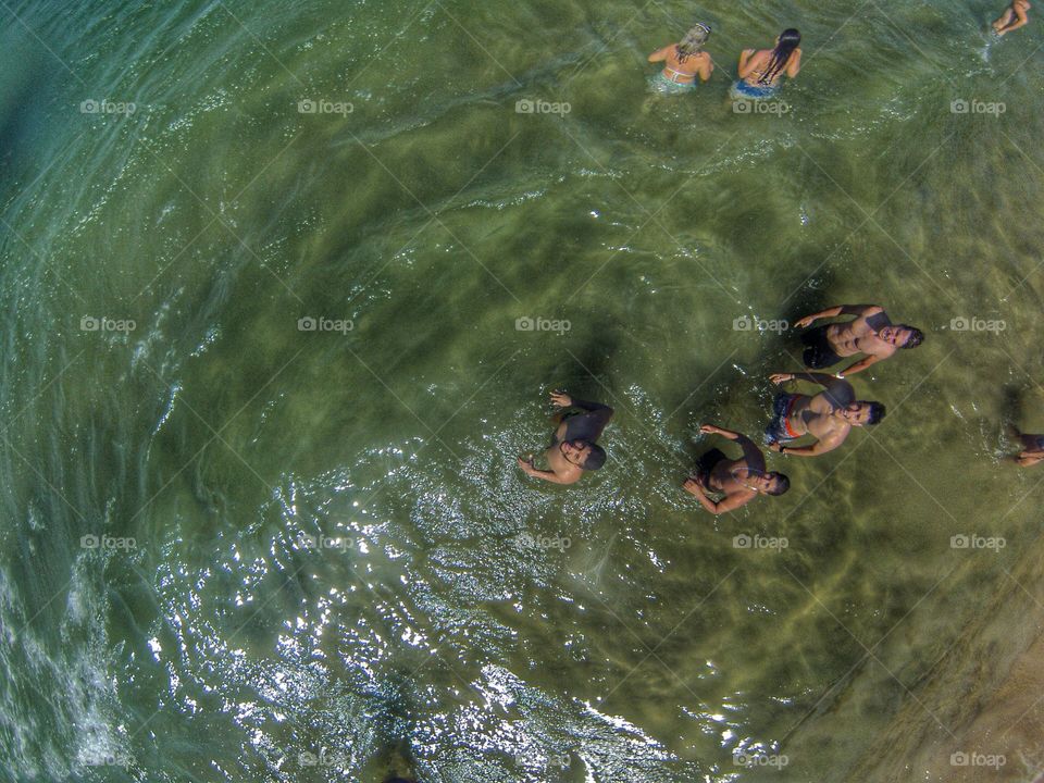 High angle view of tourists enjoying in sea
