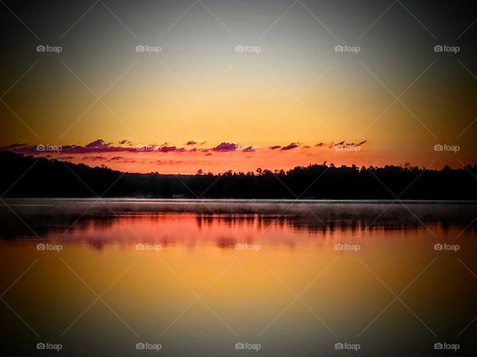 Scenic view of lake at sunset