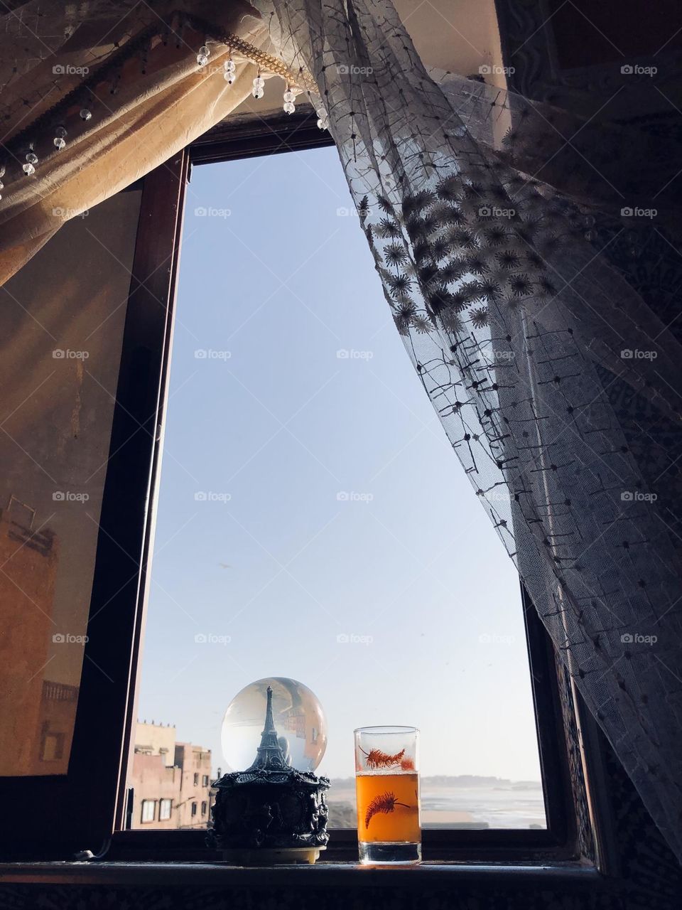 Beautiful cup and cristal ball near the Window