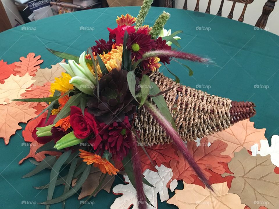 Thanksgiving centerpiece, cornucopia, sunflowers, chrysanthemum, white lilies, red roses, orange Gerber daisies. Abundance, joyful, Thanksgiving. 