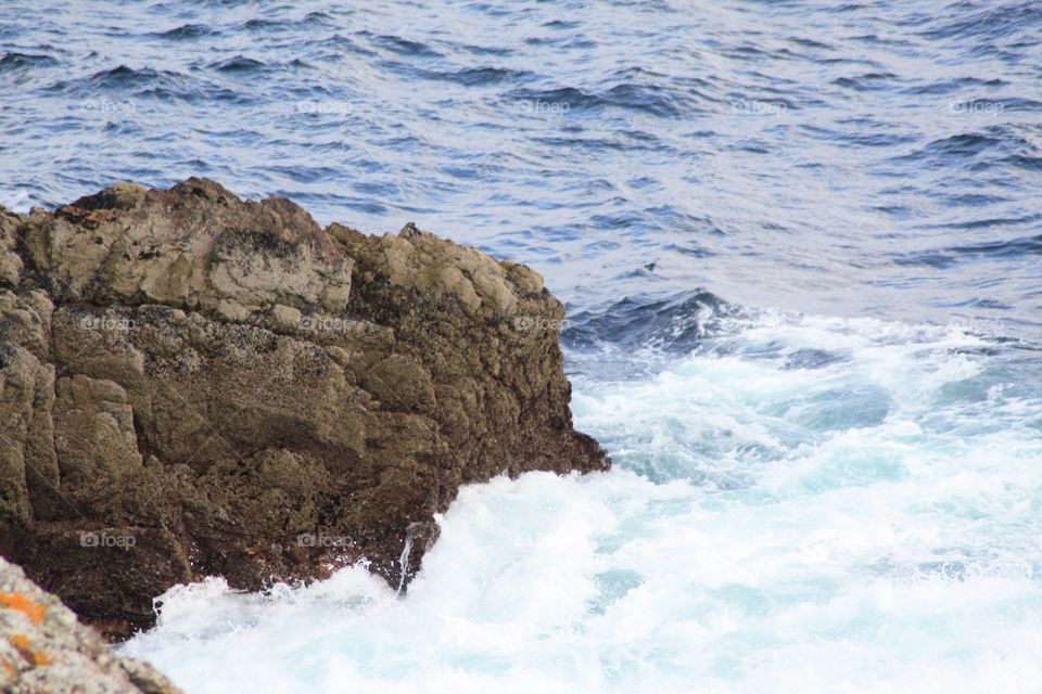 Wave crashing into rock