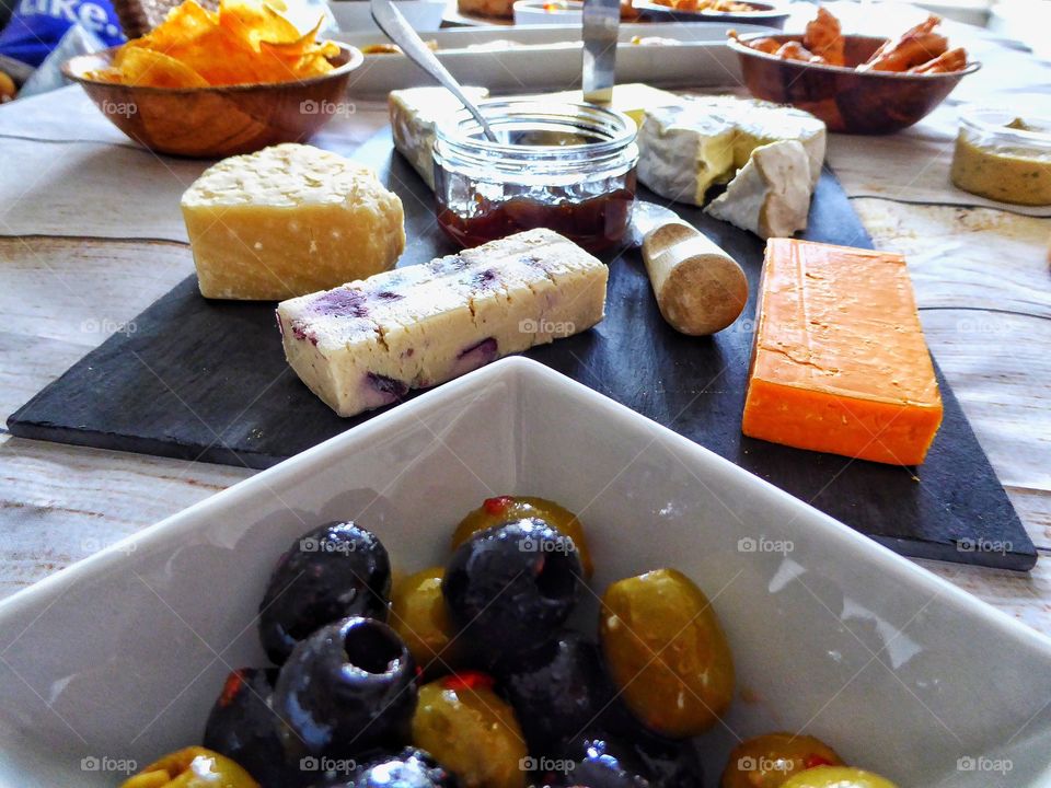 Cheese and olives on table
