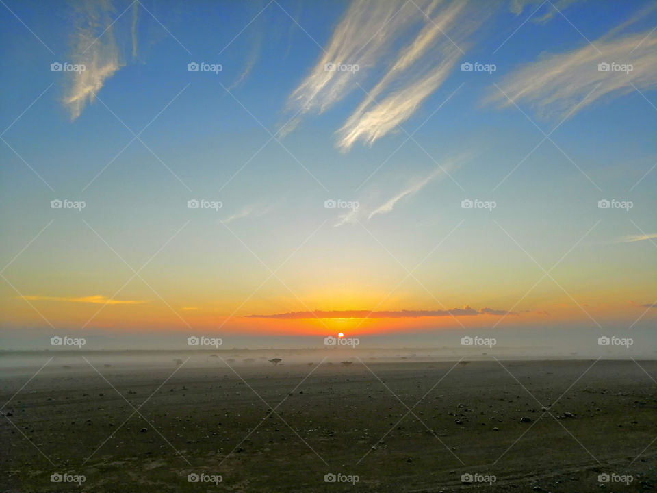 A sunrise over the desert near Al Wahbah Crater, Saudi Arabia
