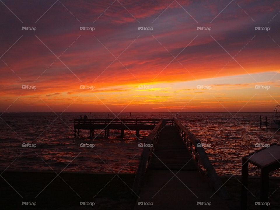 Pier over sea during sunset