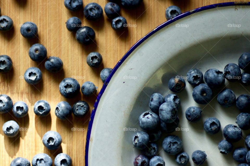 Fruits! - Blueberries on a vintage enamel plate on bamboo in natural light