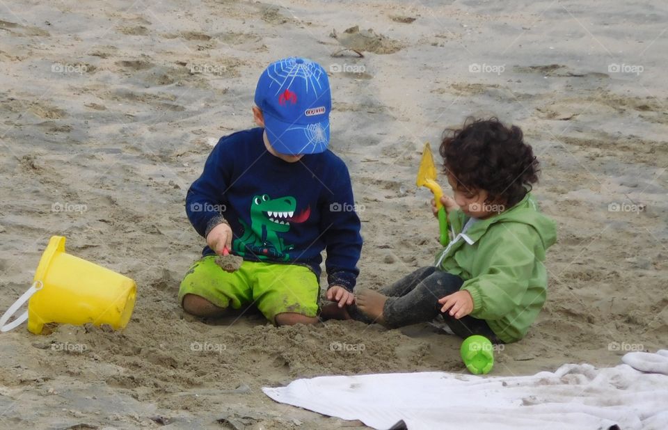 Two playing in the sand