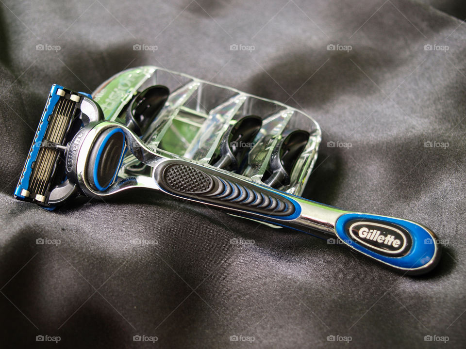Gillette razor and blade set, on a black silk material.