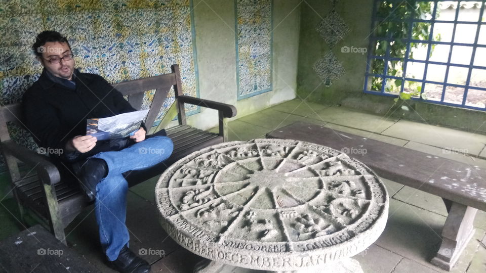 reading a map in mount Stewart in North Ireland beside a stone zodiac table