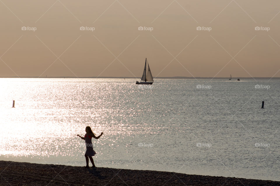 “Dancing in the Moonlight” - a young girl dances at the beach feeling happy and carefree. 