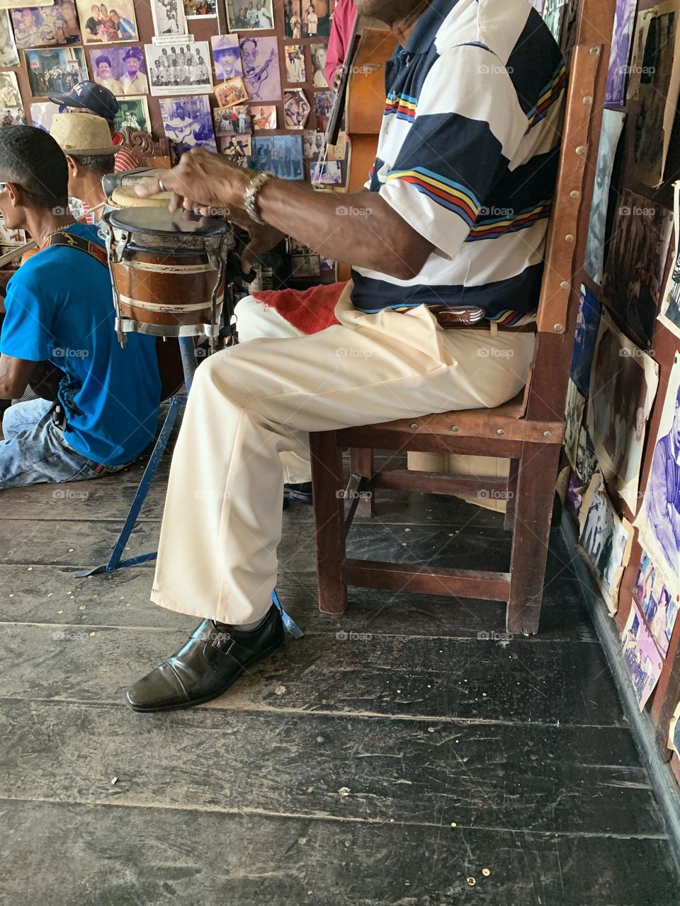 Playing an Instrument - Playing the bongo drums during a jazz jam session - A person who plays or uses a musical instrument as their hobby or job, is musician 