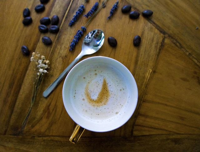 Coffee on the table with a silver spoon and coffee beans