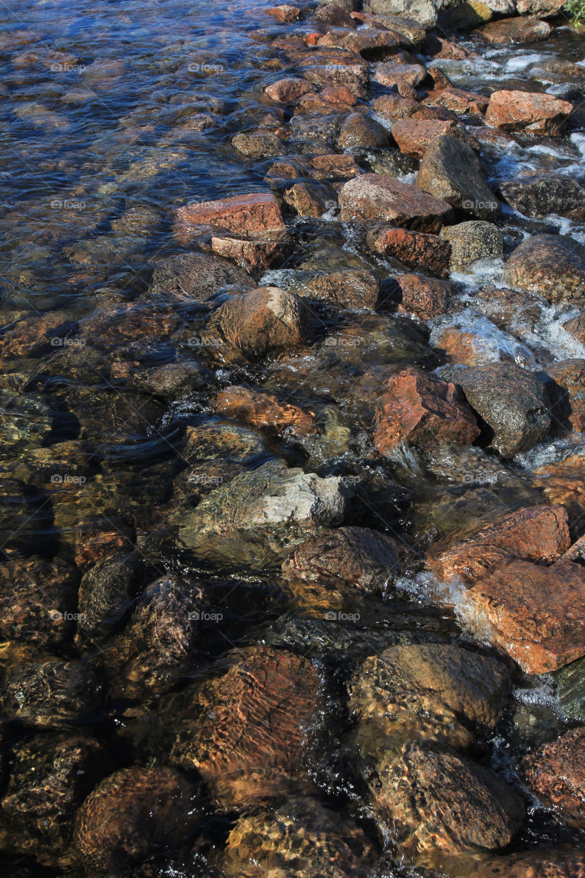 coastal stones under the rolling water