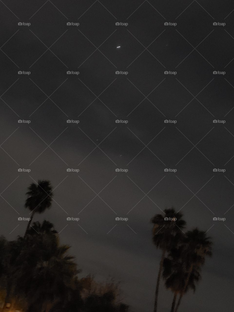 the sky lit with the moon light and a single star above