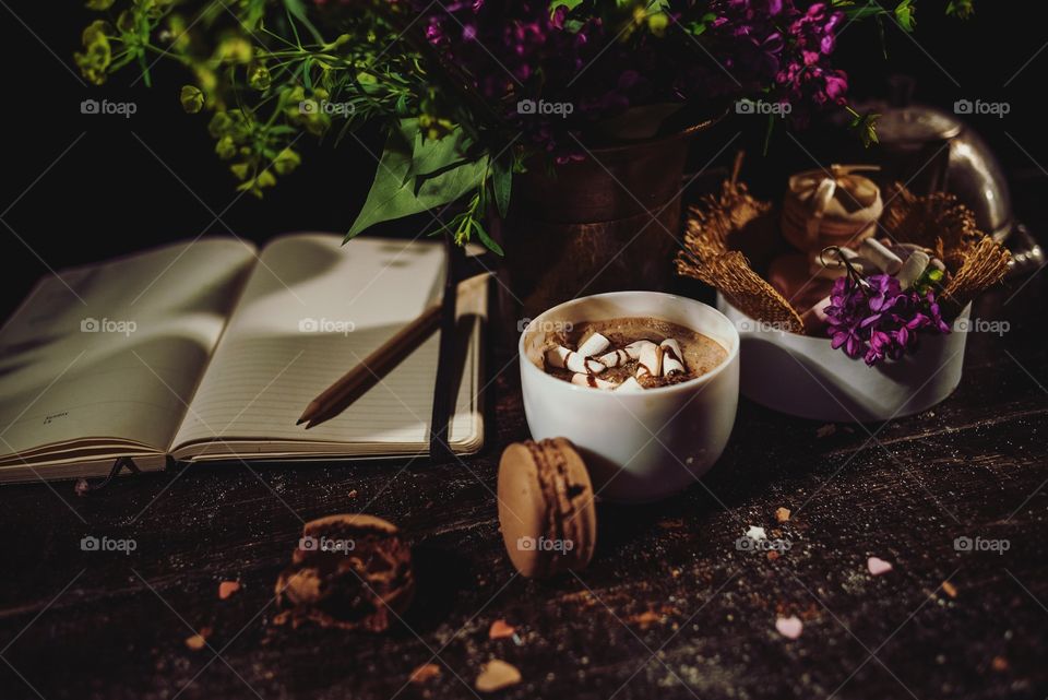 Hot chocolate with macaroons on a wood table 