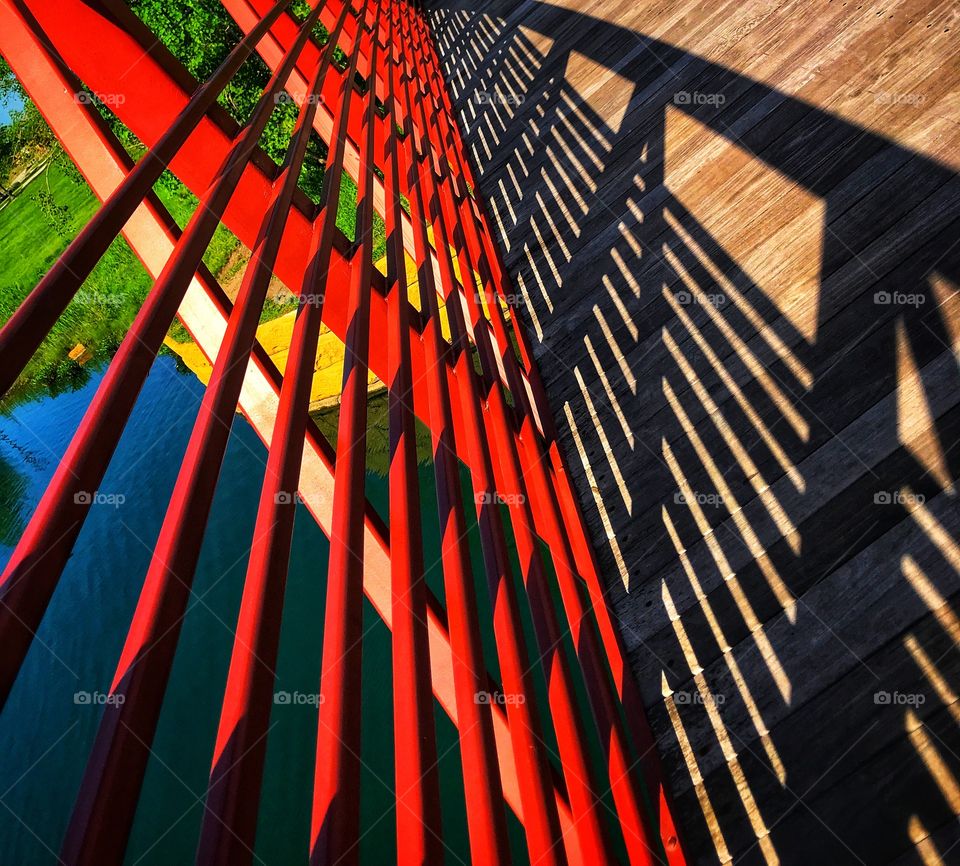 Side of a red bridge and its shadow—taken in Munster, Indiana 