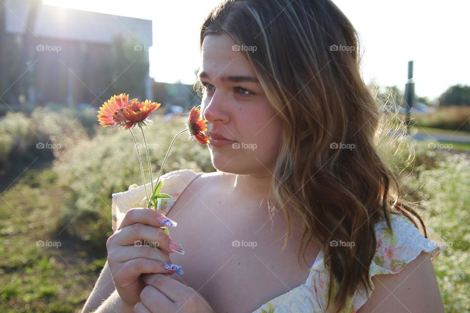 Young lady smelling flowers