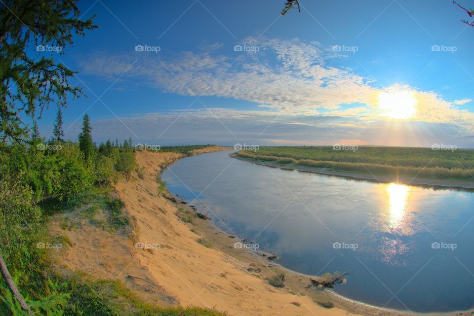 Morning on the north river. The sun rises, illuminating the river and the surrounding area.