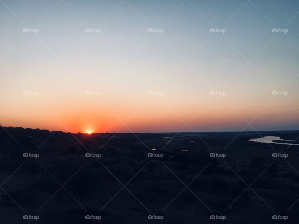 Sunset over the river and vegetation. 