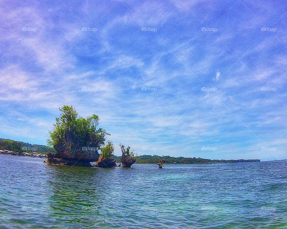 A lonely rock formation in the middle of the ocean