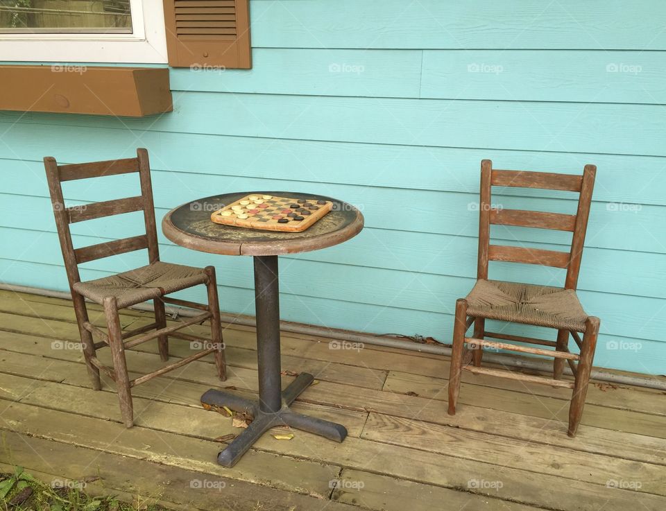 Let's Play Checkers. Old fashion front porch with checker board