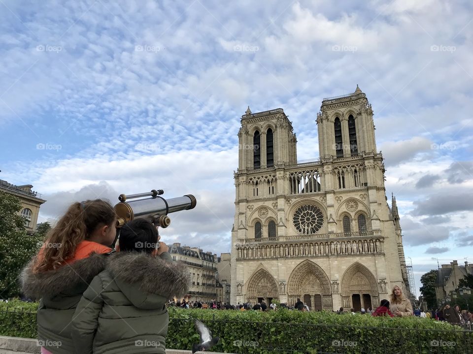 Sightseeing. Children looking at Notre-Dame de Paris