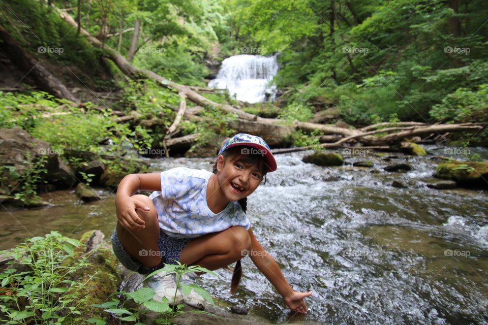 Happy cute girl on a hike by the river