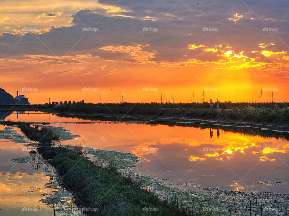 Scenic view of the red sunset sky with beautiful clouds at Adriatic sea. Slovenia travel