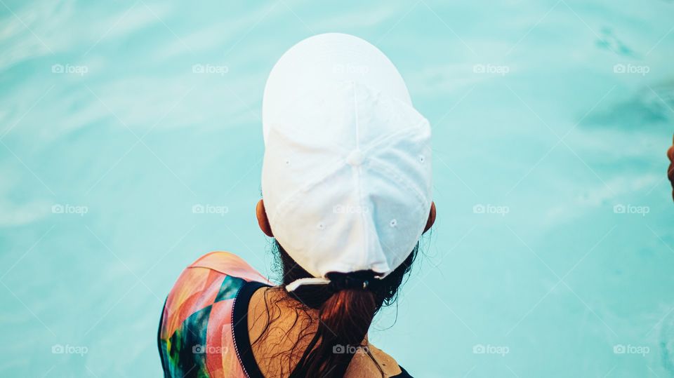 backview of a mother in a swimming pool